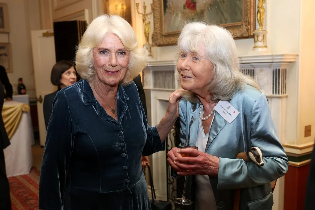 Queen Camilla and Jilly Cooper pose during a reception to mark the launch of the Queen's reading room medal at Clarence House on March 25, 2025 in London, England. Queen Camilla, accompanied by King Charles III, The Duchess of Gloucester, and distinguished authors along with members of the literary community, came together to celebrate the continued efforts of The Queen's Reading Room and its mission to inspire greater reading among people.