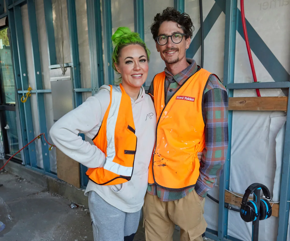 Kylie and Brad smiling on site of The Block season 20.