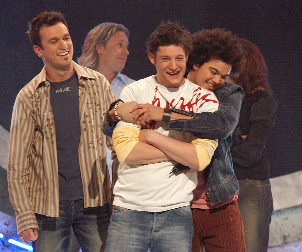 Rob Mills on the Australian Idol stage alongside Shannon Noll (left) and Guy Sebastian (right).