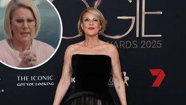 Woman standing on red carpet.