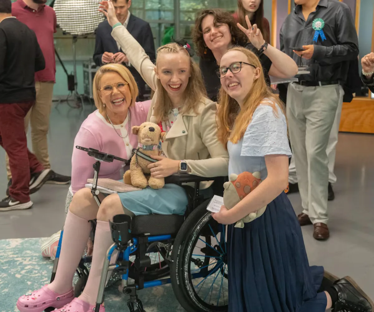 Soph from ABC TV's 'The Assembly' smiling with comedian Julia Morris, Molly and Laura.