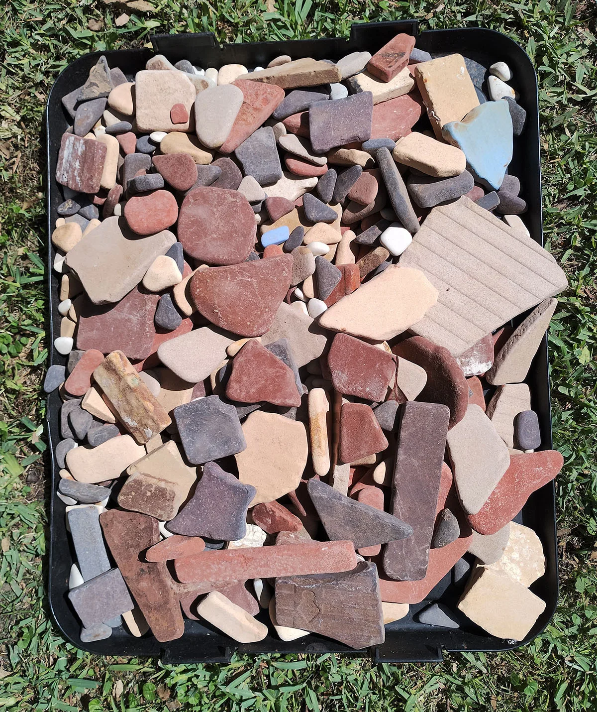 30 years worth of Walter Hood tiles collected from the beach at Wreck Bay. (Image: Supplied)
