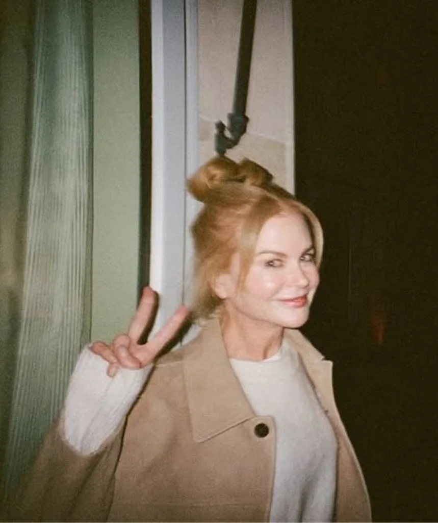 A woman poses with her fingers giving the victory sign.