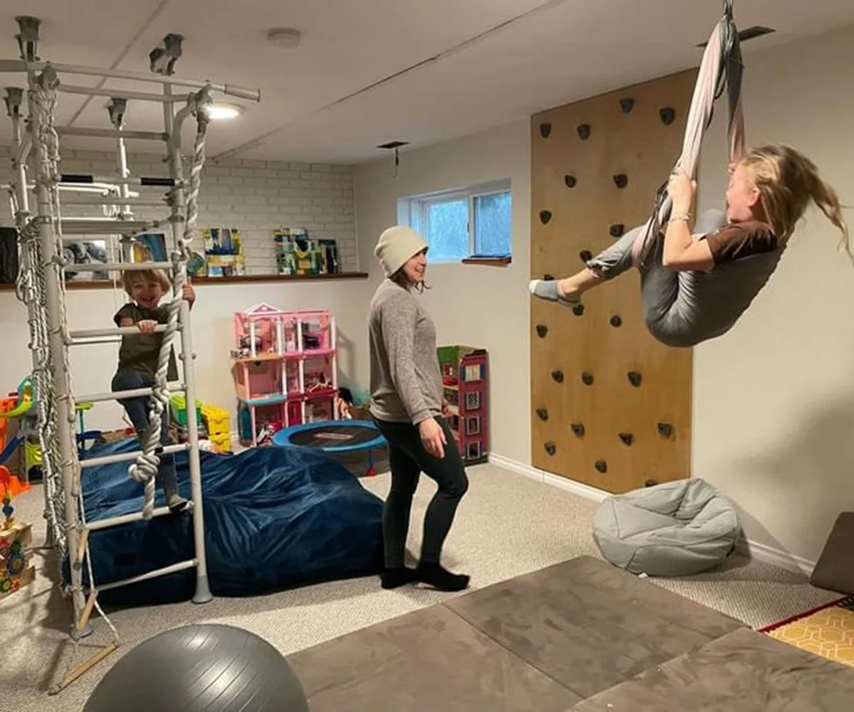 L-R, Emeric, Kelly, and Elwyn in the playroom of the house.