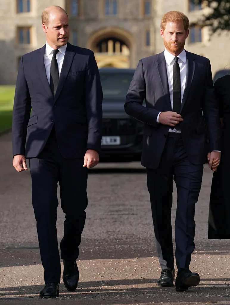 Prince William, Prince of Wales and Prince Harry, Duke of Sussex walk together to meet members of the public on the long Walk at Windsor Castle on September 10, 2022 in Windsor, England. Crowds have gathered and tributes left at the gates of Windsor Castle to Queen Elizabeth II, who died at Balmoral Castle on 8 September, 2022.