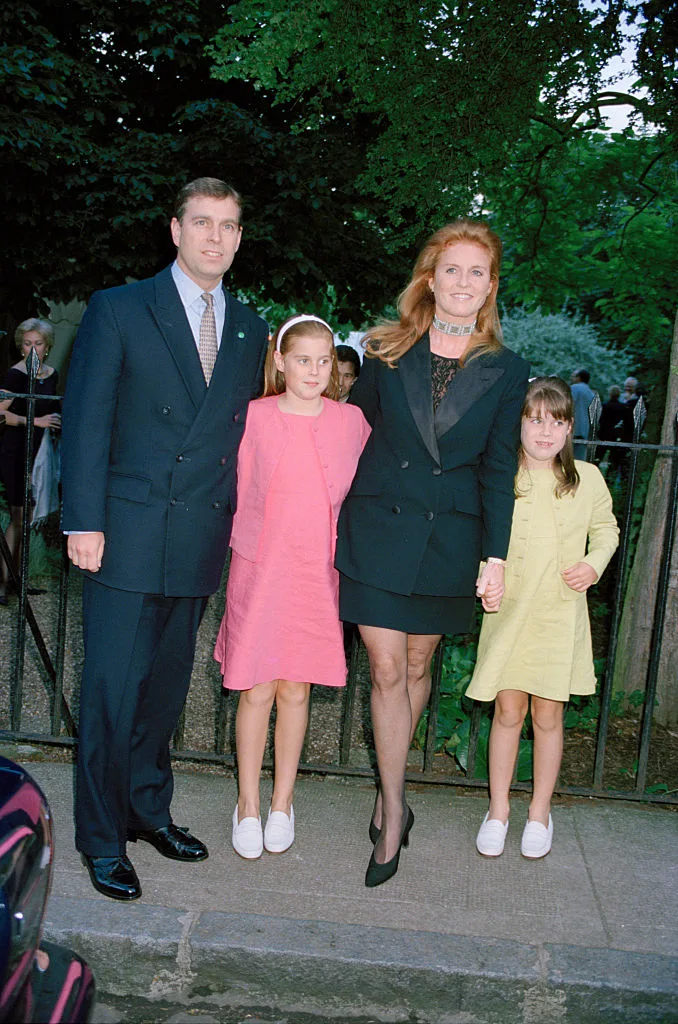 Prince Andrew, Duke of York, and Sarah, Duchess of York with their children, Princess Beatrice of York (pink dress) and Princess Eugenie of York, attending a garden party at the home of David Frost, June 1999.