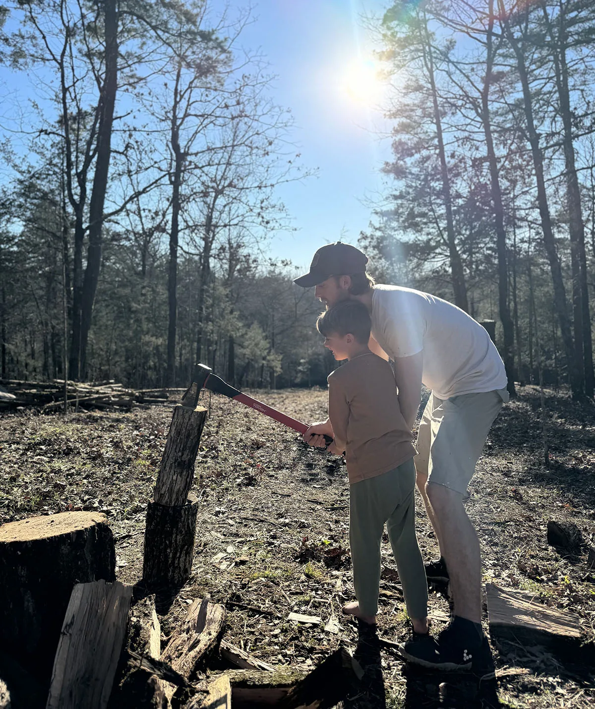 My husband Nick teaching Hudson to chop wood. (Image: Supplied)
