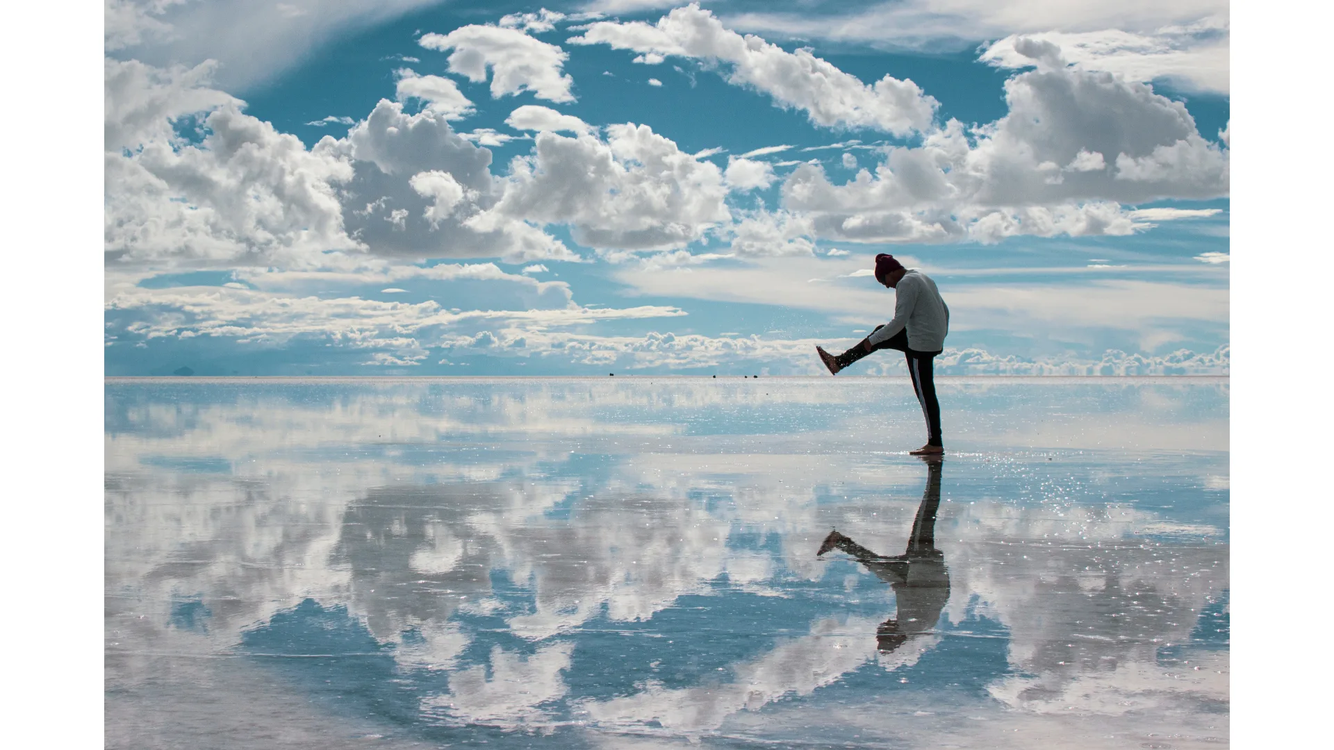 A person walks along Bolivia's salt flats after the rain.