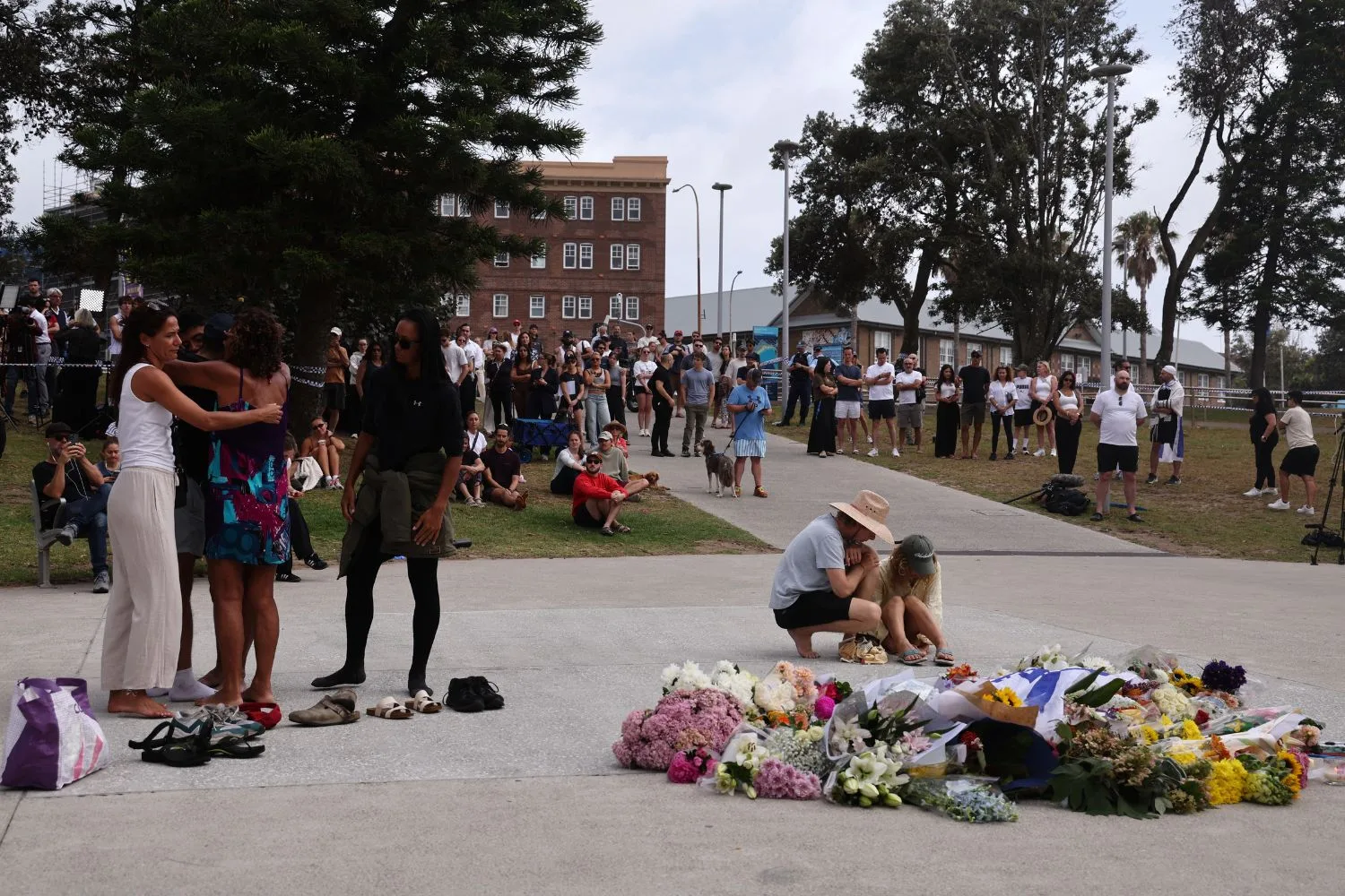 Mourners gather in Bondi the morning after the terror attack that killed at least 16.