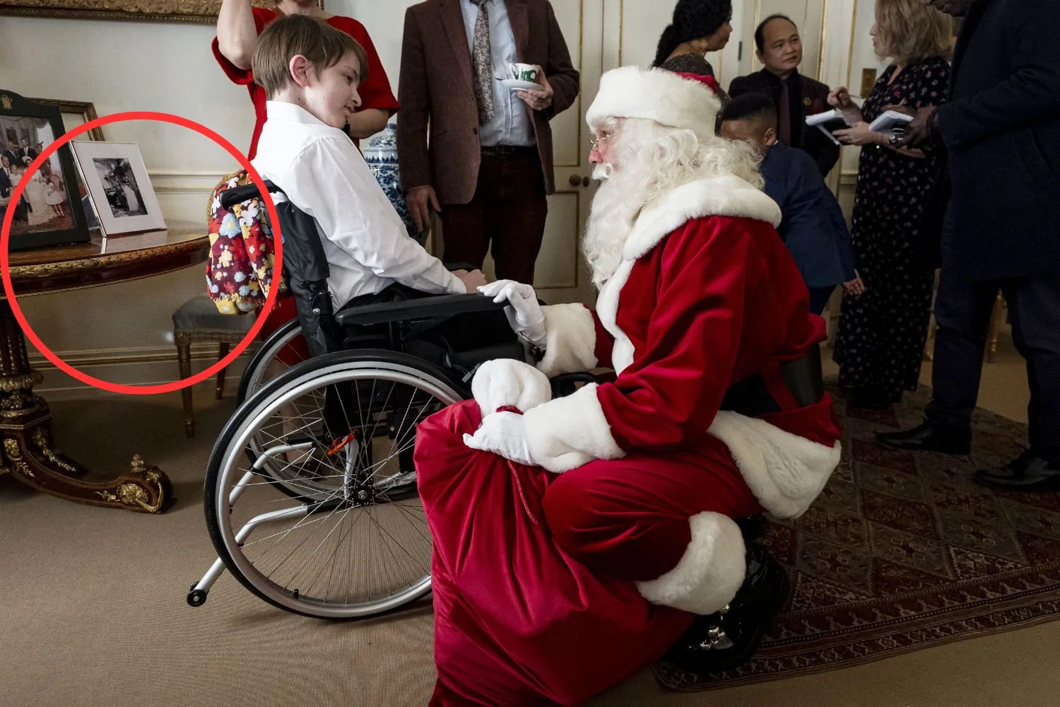 Santa chats to a child at the Clarence House christmas tea party
