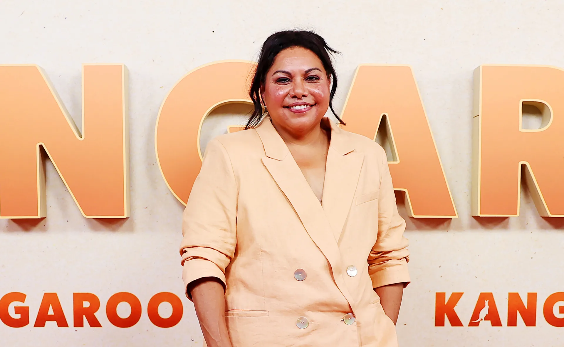 Deborah, wearing a pale apricot jacket, poses at the Kangaroo premiere