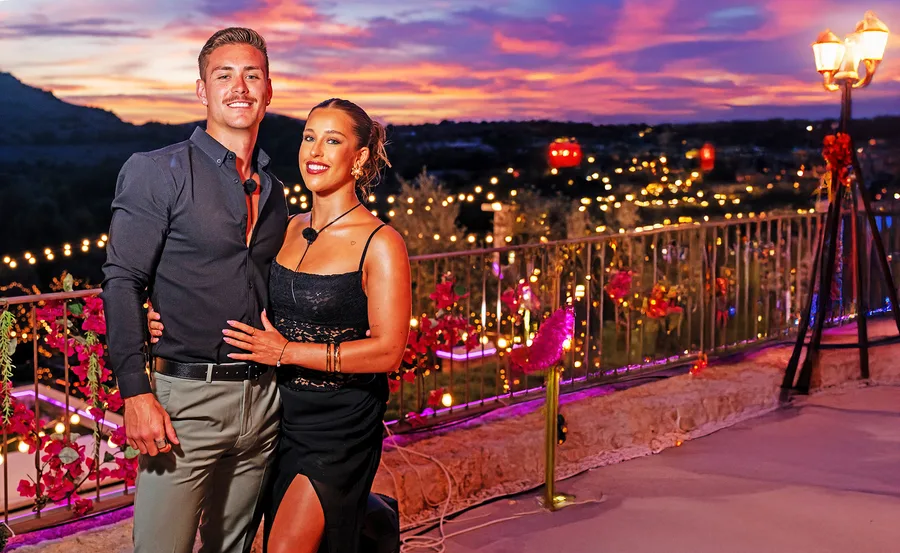 Kye and Yana in the Love Island villa with a beautiful sunset in the background.