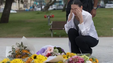 Woman mourns in aftermath of Bondi Beach attack.