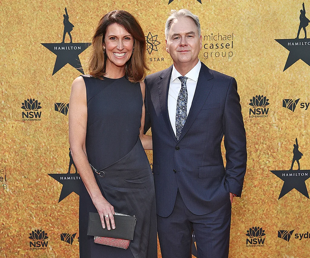 Nat Barr, in a black dress, and her husband Andrew Thompson, in a suit, pose at the Hamilton premiere