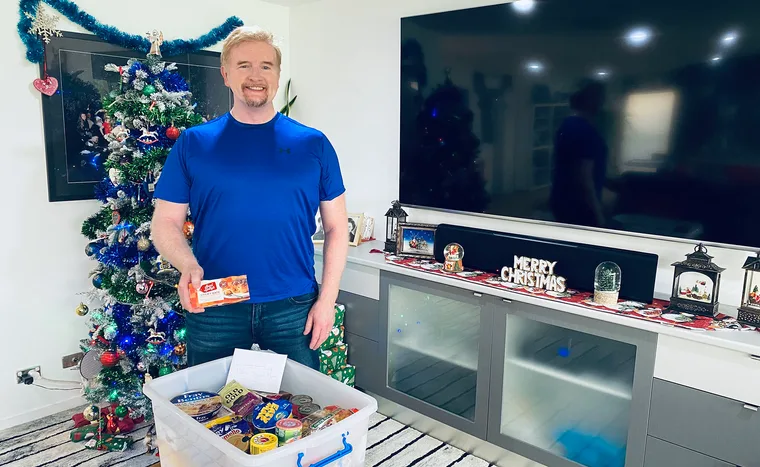 Brian M Logan with Christmas Hamper. (Image: Supplied)