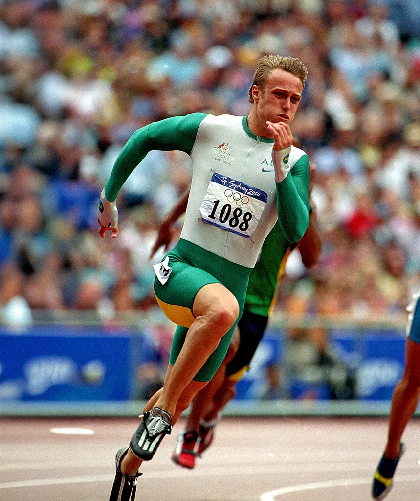 Matt running at the Sydney Olympics, with a crowd visible behind him