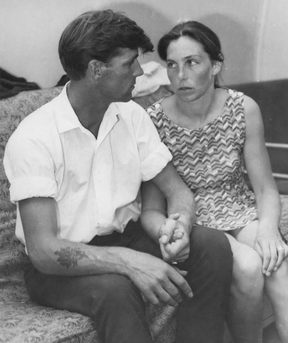A black and white image of a man and a woman.
