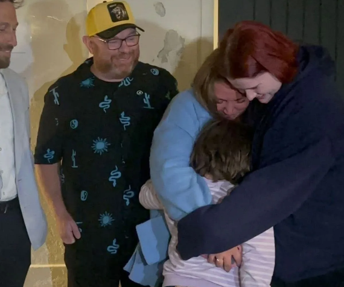 The hug that says it all: Matilda's mum reunited with the hero woman who saved her other daughter Summer. (Image: Supplied)