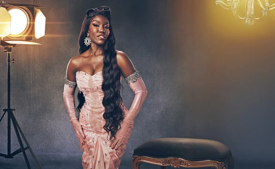 Boz from Real Housewives of Beverly Hills looking glamorous in a champagne coloured dress with matching gloves and her hair out long.