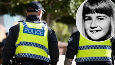 An image of the backs of two police officers and an inset of a child's image.