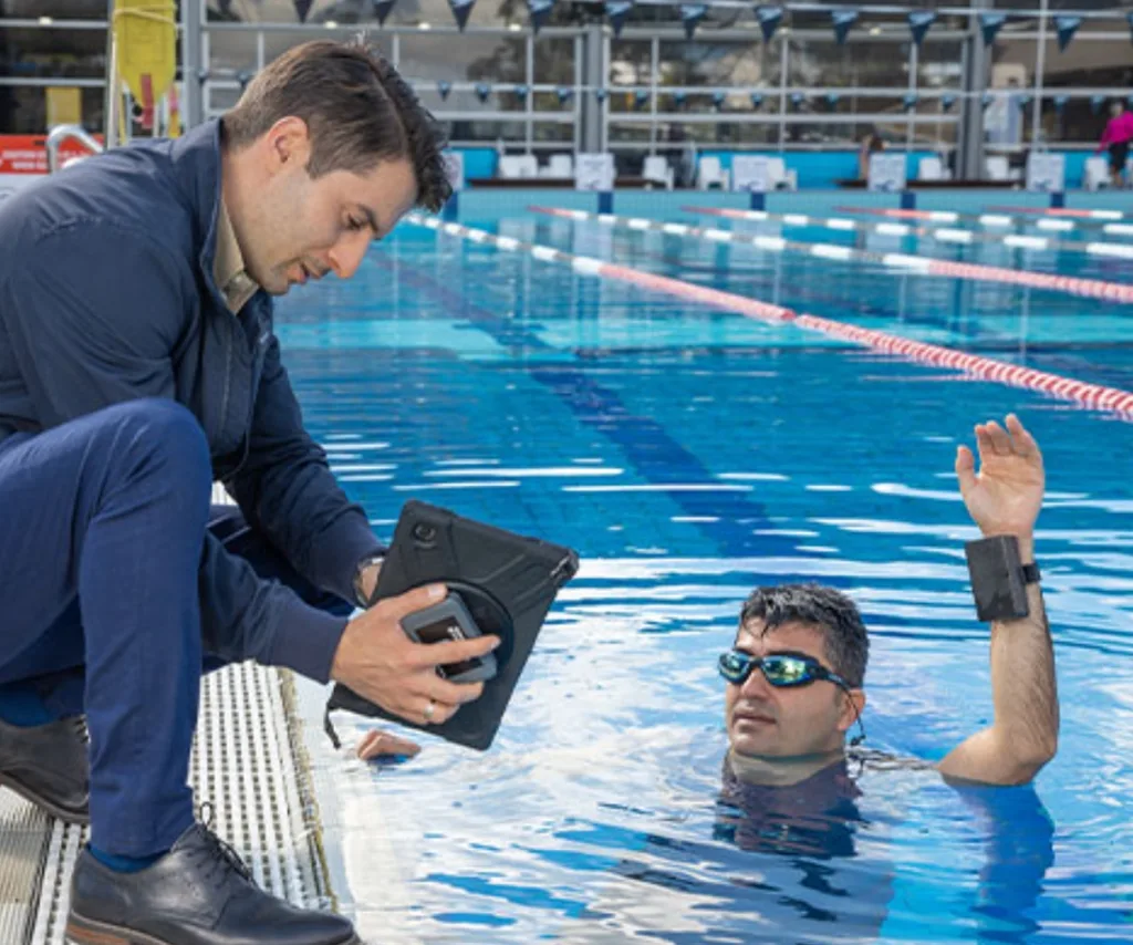 Two men at a swimming pool.