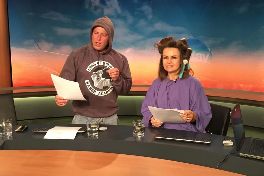 Karl Stefanovic in a hoody at the Today desk alongside Lisa Wilkinson with rollers in her hair, both reading from scripts