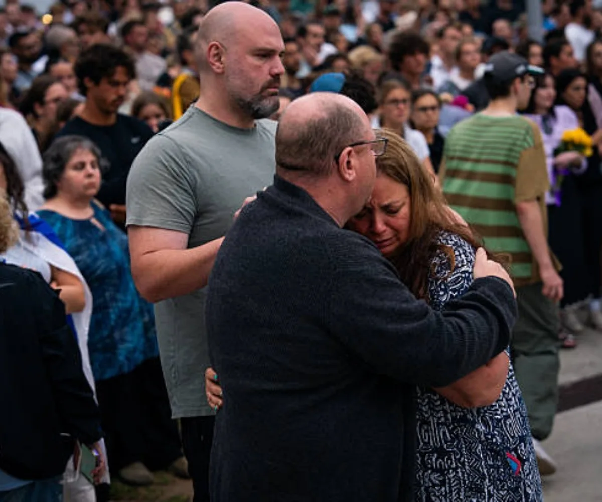 Grieving family: Valentyna and her husband Michael, pictured at a Bondi vigil, want to find the hero woman and thank her. (Image: Getty)