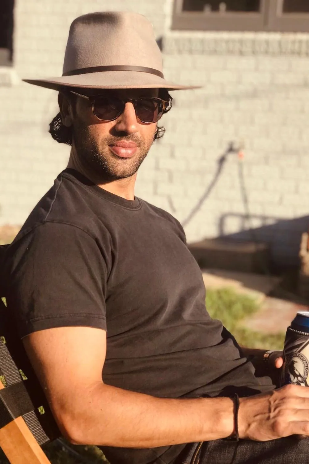 Sarah Abo's husband Cyrus in a wide-brimmed hat