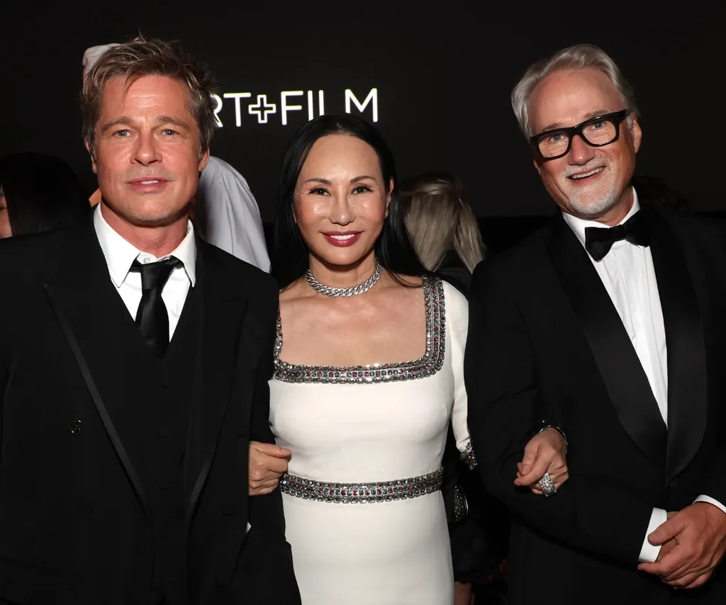 Brad Pitt and Eva Chow pose with honoree David Fincher during a celebratory evening.