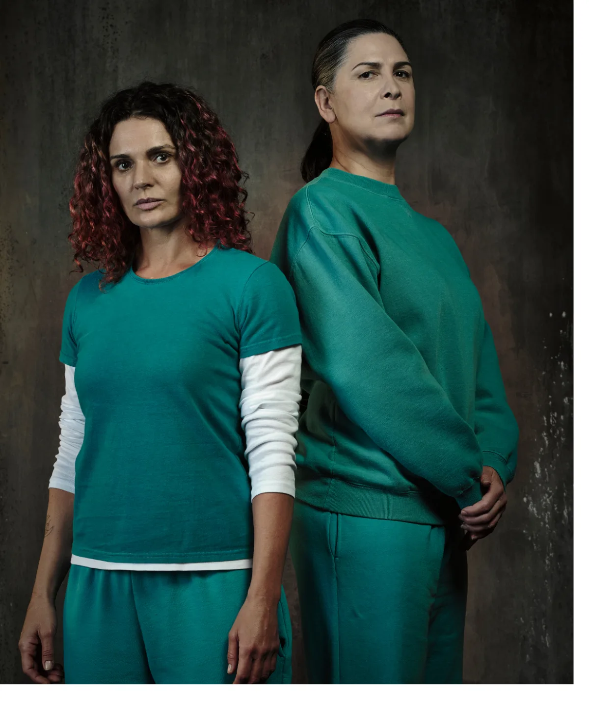 Two women in teal tracksuit