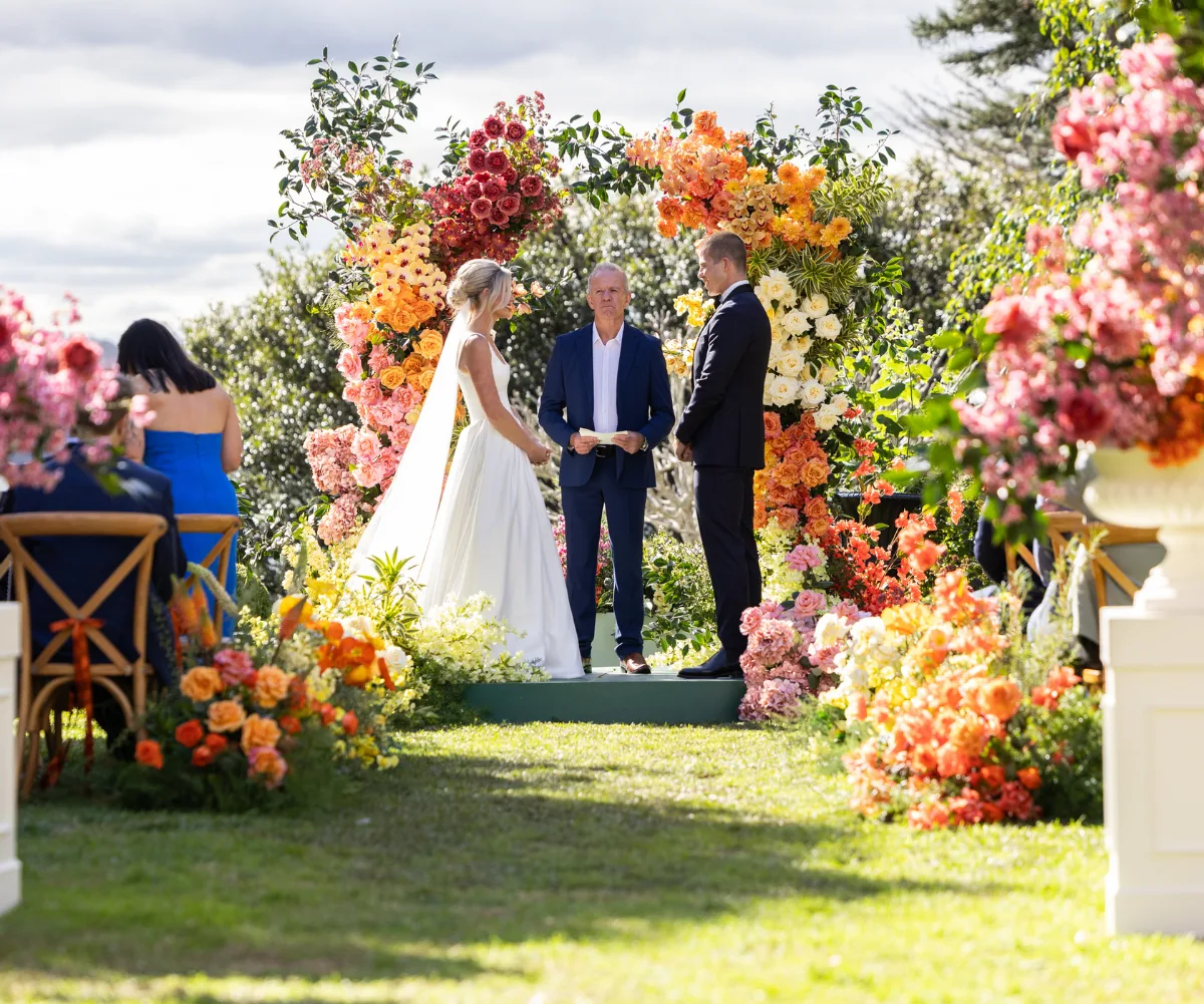 Stephanie and Tyson at the end of the aisle holding hands as they get married on MAFS!