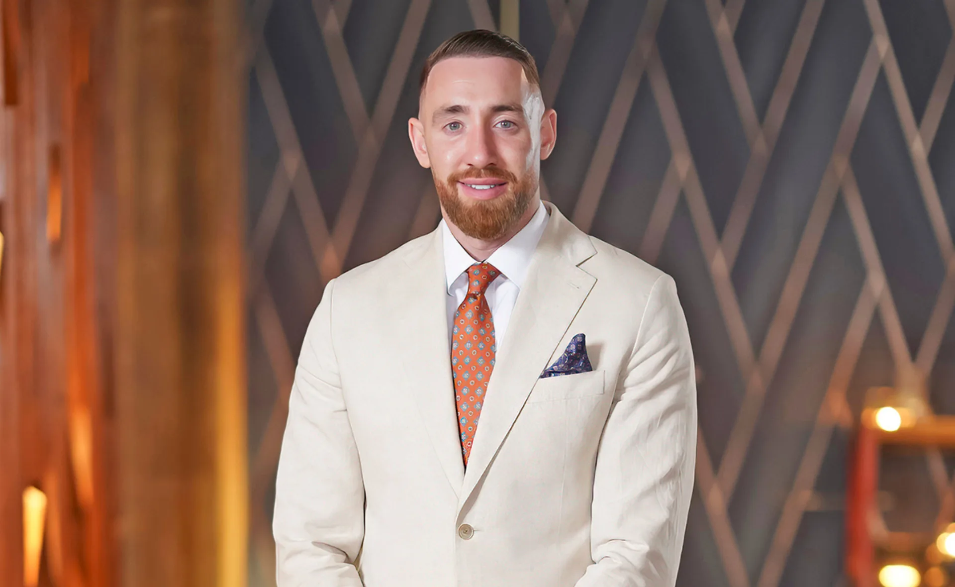 Danny from MAFS in a cream suit behind the scenes at a Dinner Party.