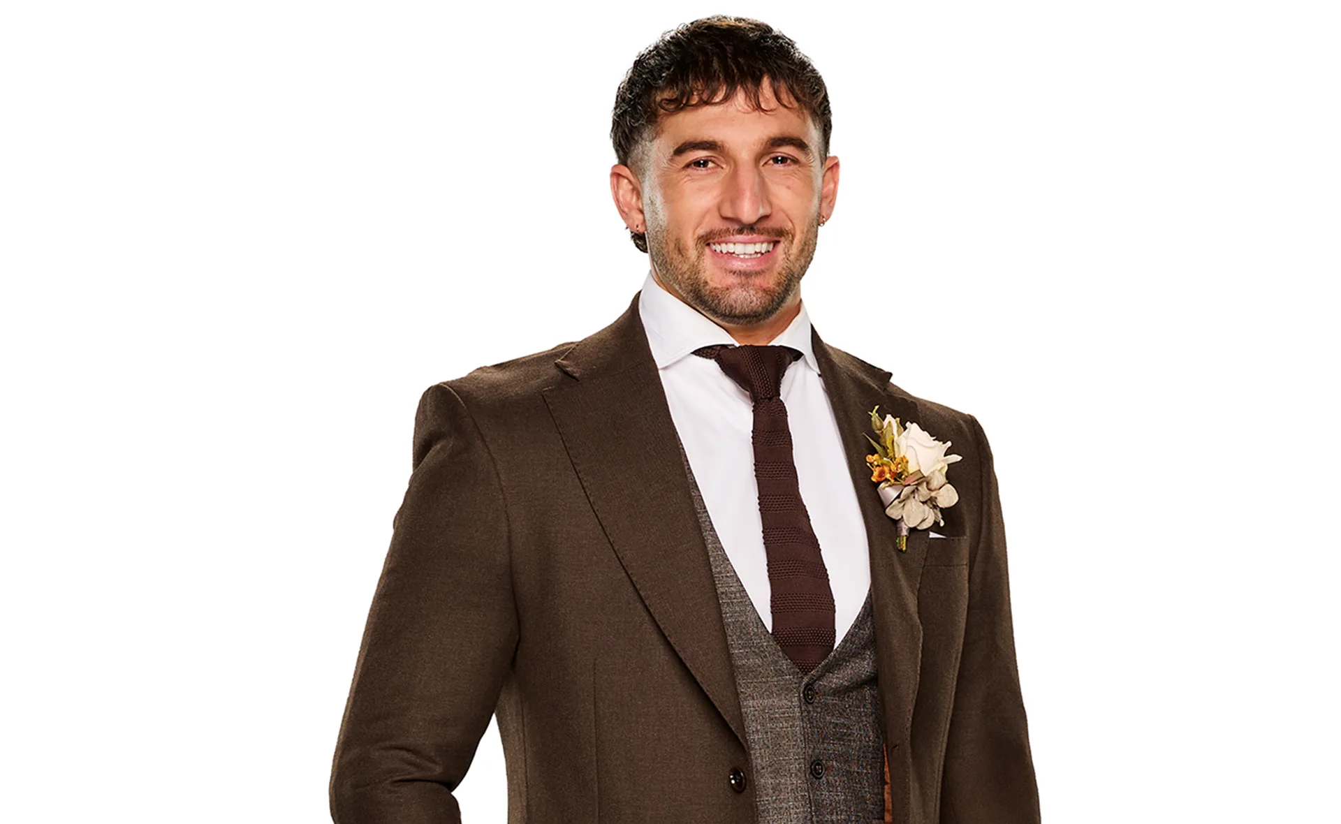 Luke Fourniotis in a brown suit smiling for a promotional shot for the latest season of Married at First Sight Australia.