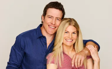 Stephen Peacocke, in a blue shirt, stands with his arm around Bonnie Sveen's shoulders