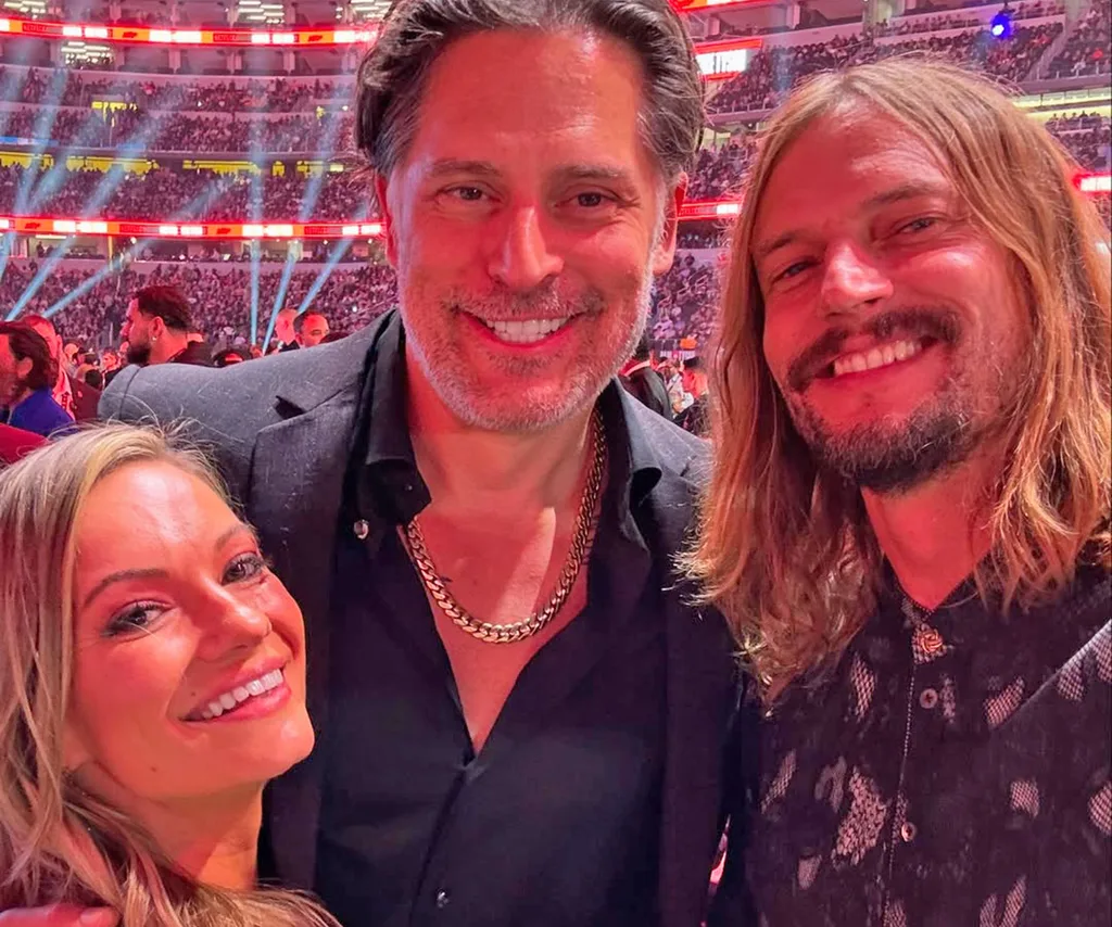 David, long hair worn down, smiles, standing close to Joe Manganiello and Caitlin O'Connor