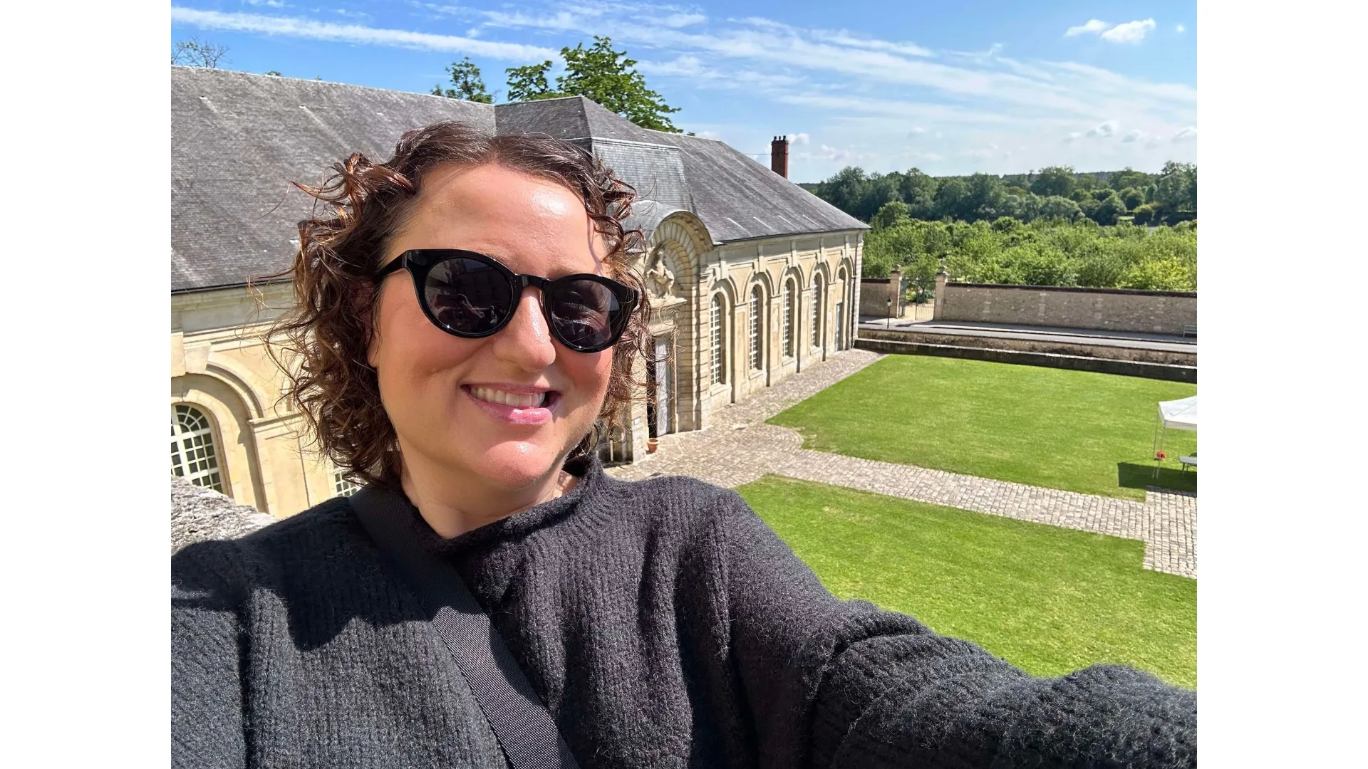 The author on the balcony of a castle.