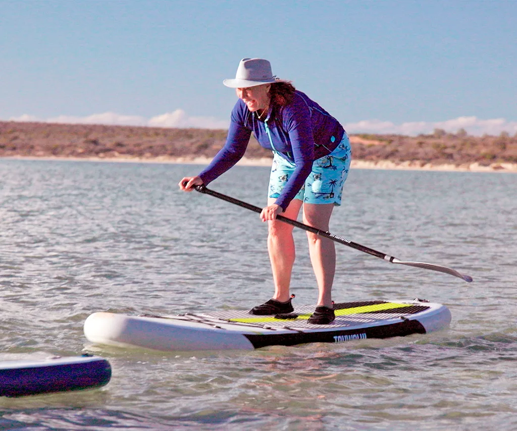 Lisa Millar tries to balance on a standup paddleboard
