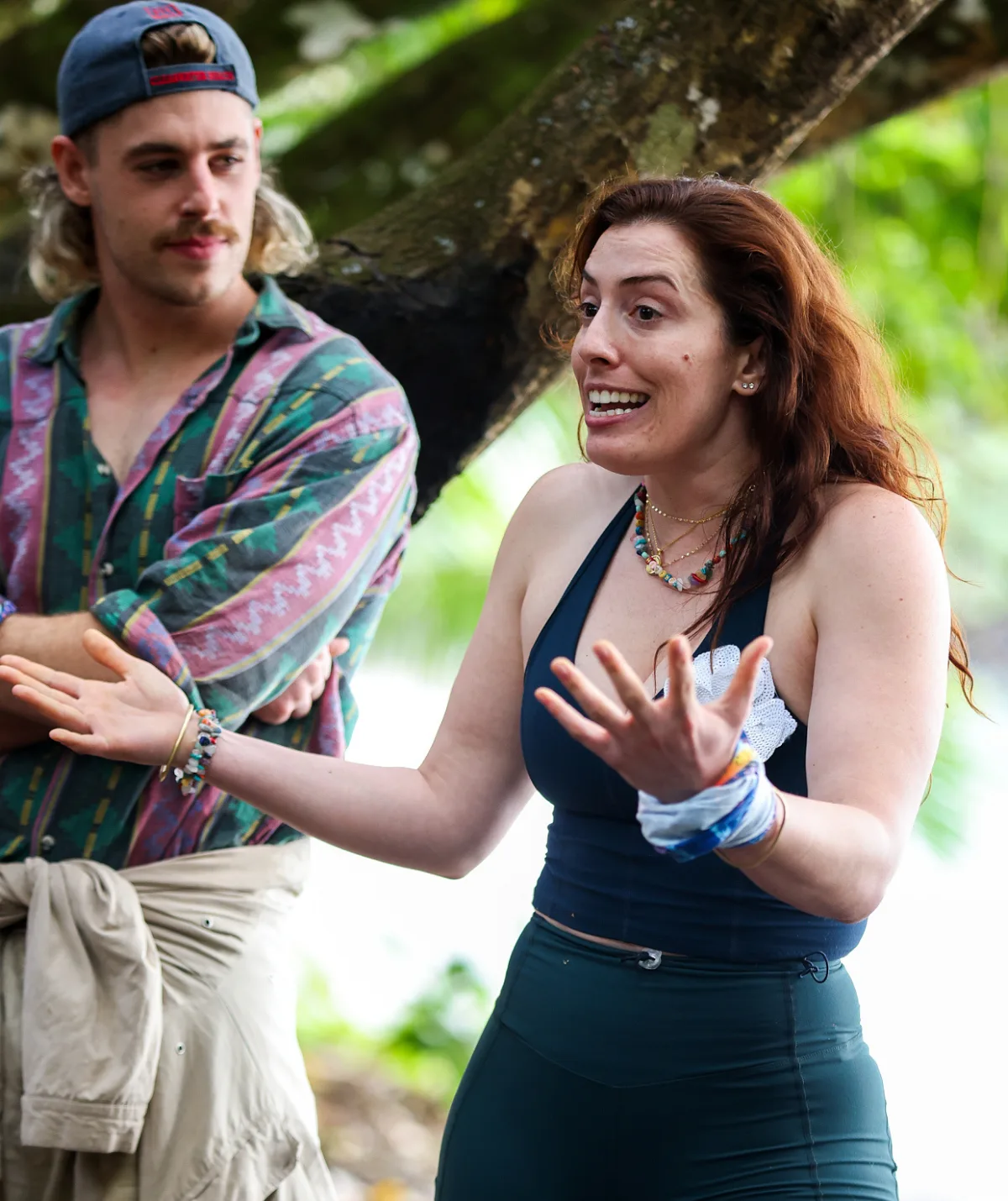 Eliza has her hands outstretched, while Jackson, in a patterned shirt, looks on