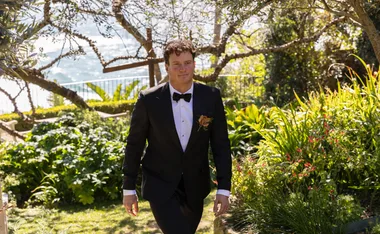 Sam in a suit walking through a garden on his wedding day on MAFS.