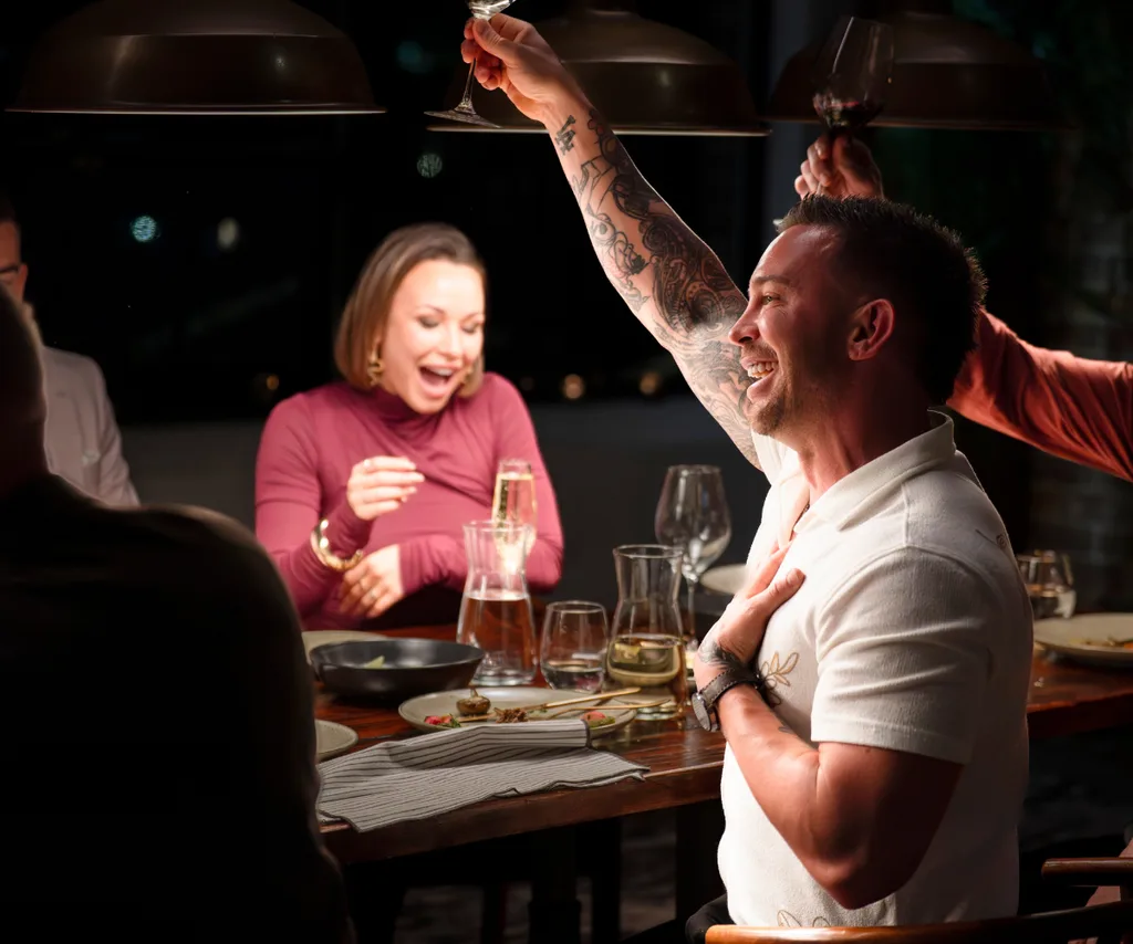 Chris raises a glass at the MAFS Dinner Party to celebrate the announcement that he is going to be a dad!