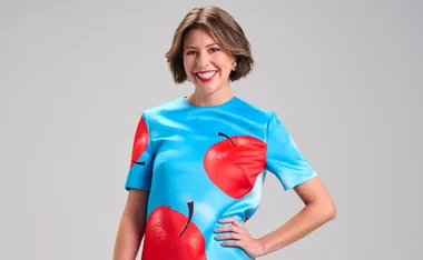 Sofia Levin in a beautiful blue dress with red apples on it.