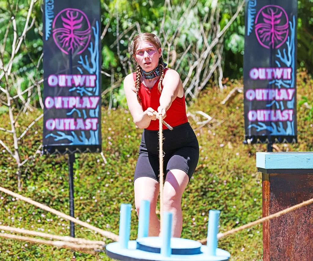 Keeley leaning backwards, holding onto a rope, during a Survivor challenge