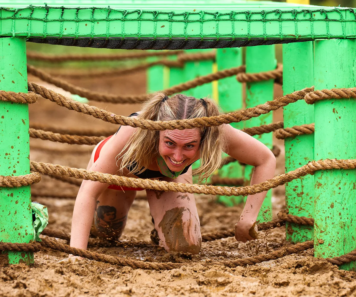 Faith, crawling through ropes in a challenge