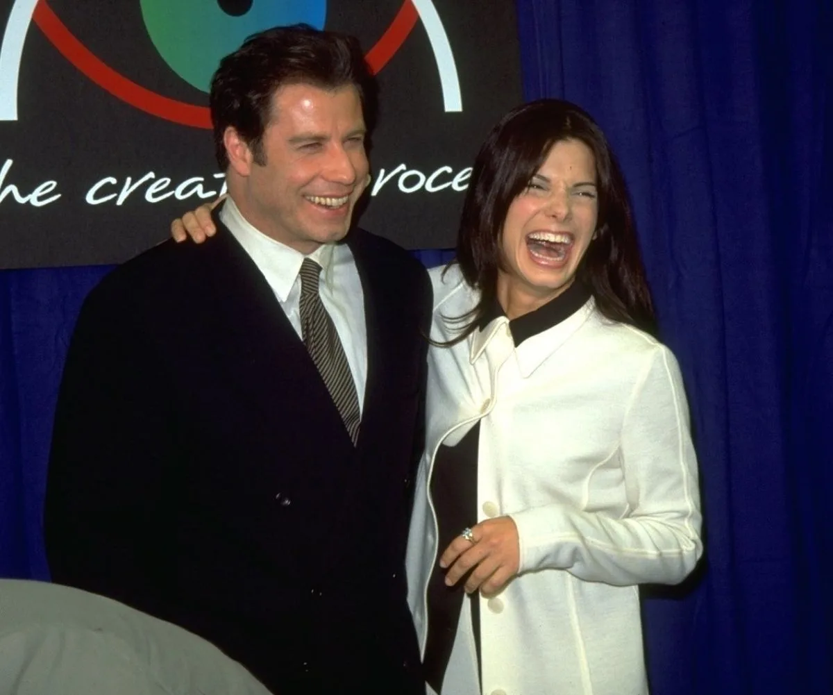 John Travolta and Sandra Bullock smiling together