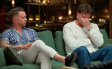 MAFS' Sam and Chris sit on the commitment ceremony couch. Sam cries in his hands as Chris looks on.
