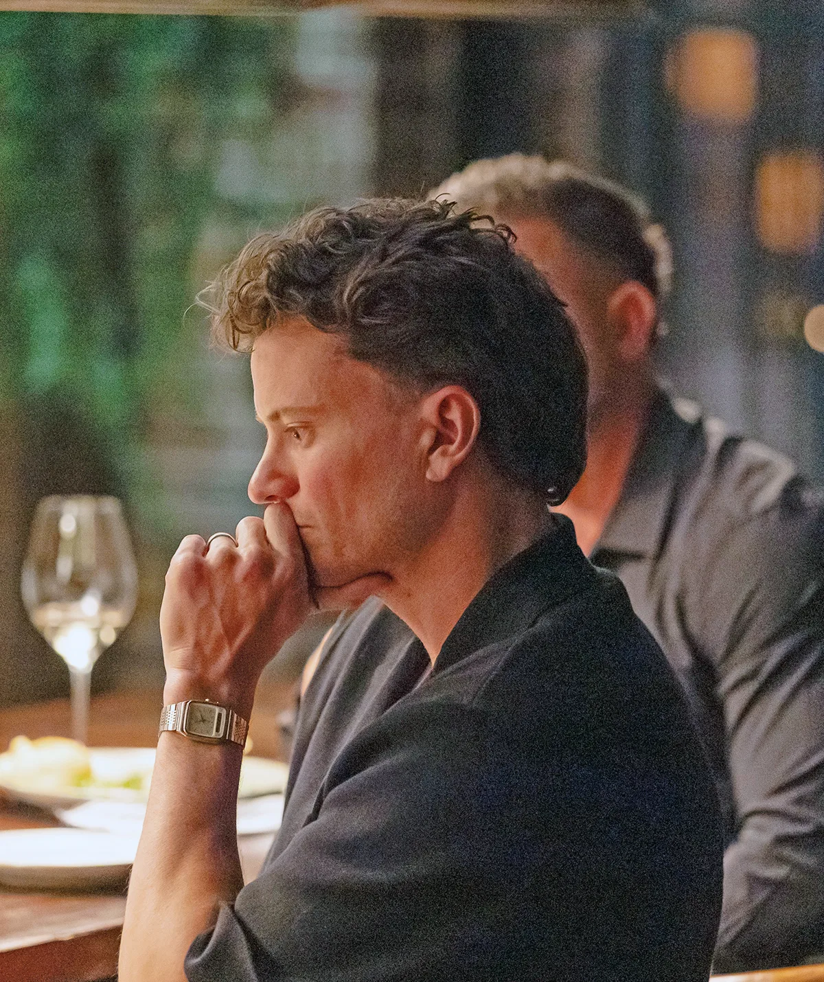 Sam at the MAFS dinner party table with his hand to his mouth looking despondent.
