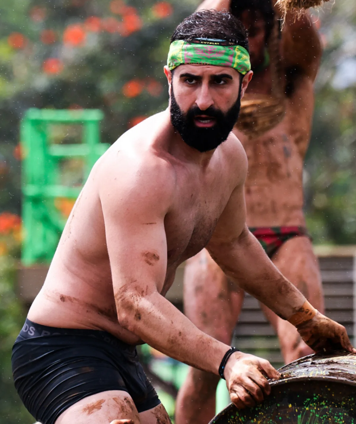 Johnson, wearing just shorts and a bandana, looks intense during a challenge