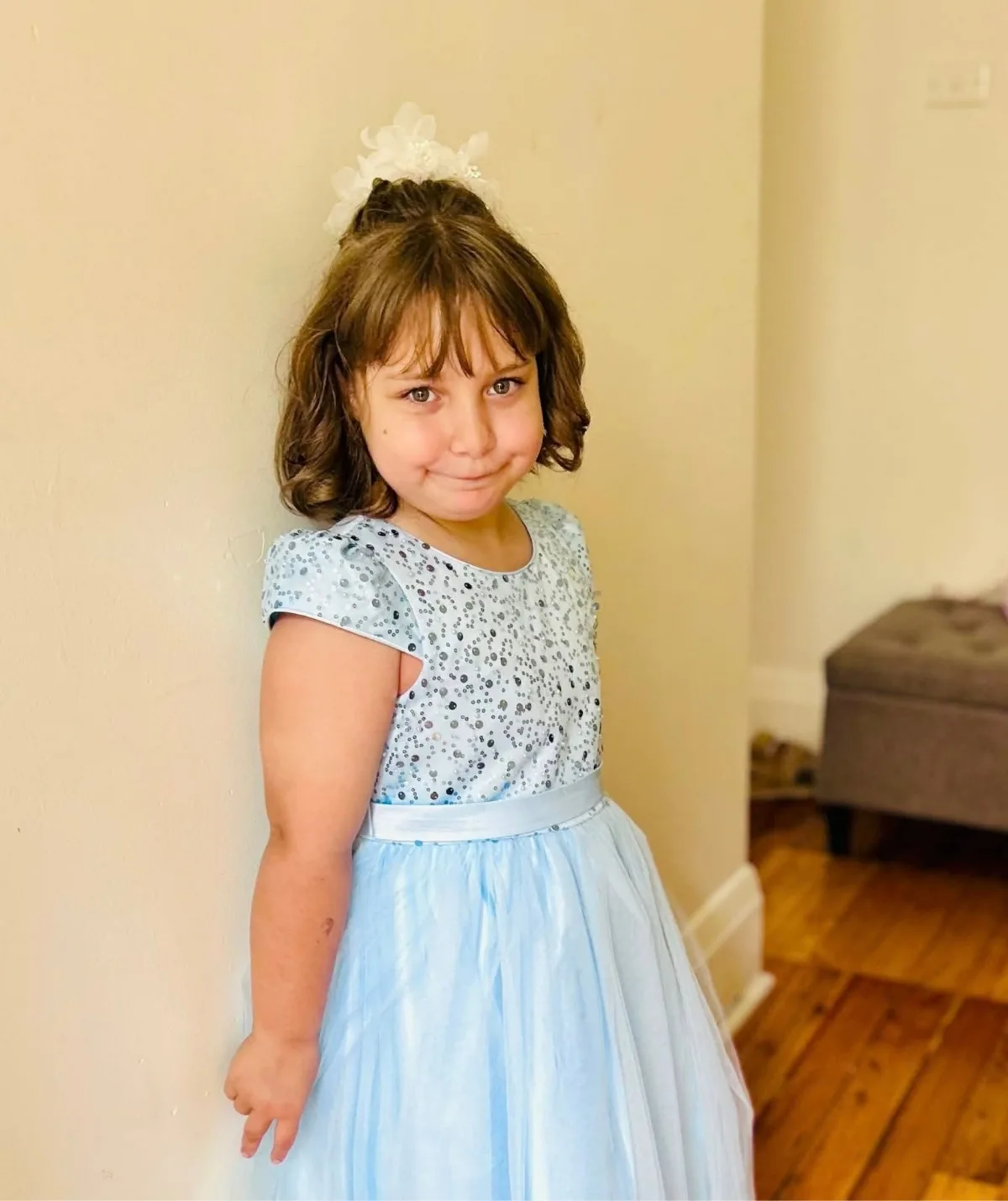 A little girl in a blue dress.