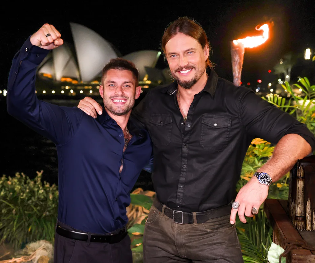 Caleb was crowned winner of Australian Survivor: Redemption, pictured here alongside host David Genat in front of the Opera House.