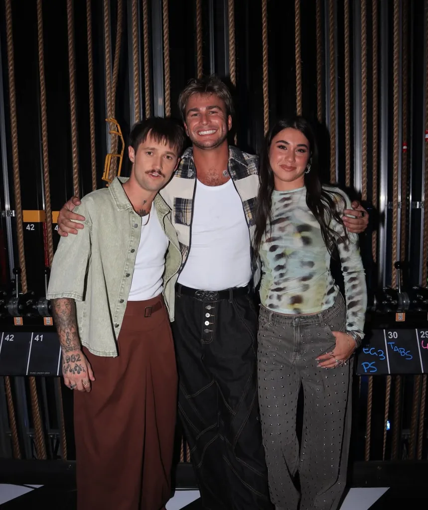 Kesha Oayda standing beside Harry Lamb (middle) and Kalani Artis (left) smiling for a photo.